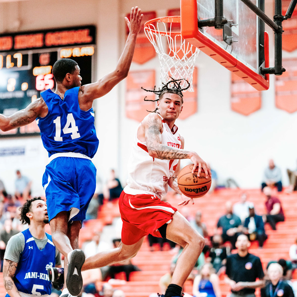 A basketball player taking a contested layup during the 2023 Portsmouth Invitational Tournament.